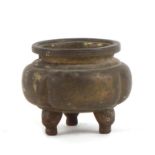 A small Chinese bronze three legged censer, 6cms (2.25ins) high.