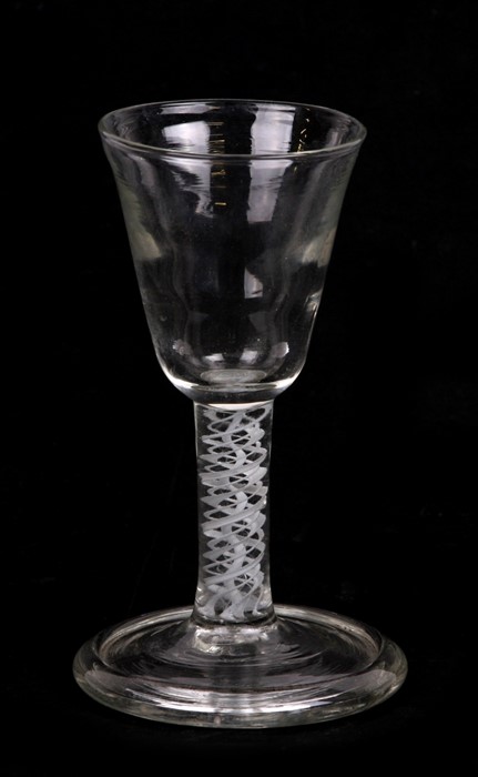 A late 18th / early 19th century wine glass with triple helix air twist stem, 13cms (5ins) high.
