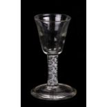 A late 18th / early 19th century wine glass with triple helix air twist stem, 13cms (5ins) high.