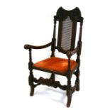 A 17th century style carver chair with bergere caned back and upholstered drop-in seat.