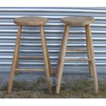 A pair of stripped elm kitchen stools.