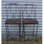 A pair of metal garden chairs.