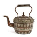 A copper kettle with brass and white metal overlaid decoration, 28cms (11ins) high.