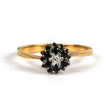 An 18ct gold diamond and sapphire cluster ring, approx UK size 'M'.