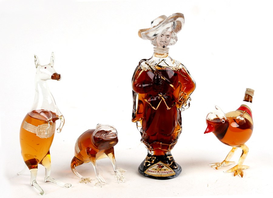 A group of four unopened novelty liqueur bottles, the largest 18cms (7.2ins).