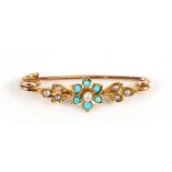 A yellow metal turquoise and seed pearl set bar brooch.