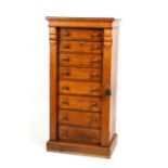 A Victorian oak Wellington chest with eight graduated drawers, standing on a plinth base. 54cm (21.