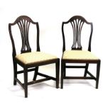 A pair of 19th century mahogany chairs with drop-in upholstered seats, on square tapering legs.