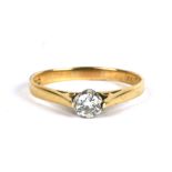 An 18ct gold diamond solitaire ring, approx UK size 'M'.