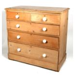 A Victorian stripped pine chest of two short and three long graduated drawers, 106cms (42ins) wide.