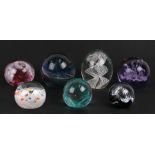 A group of glass paperweights to include a Caithness Moonflower paperweight (7).