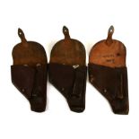 Three brown leather pistol holsters (possibly for the P64 Makarov pistol)