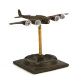 A WW2 brass four engined Bomber Aircraft standing on its ashtray base. Wingspan 17cms (6.75ins)