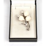 A sterling silver and ivory flower brooch, 6cms (2.25ins) high.