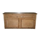 A Victorian stripped pine dresser base with two frieze drawers and cupboards beneath, 183cms (74ins)