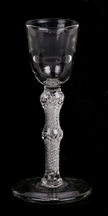 A late 18th / early 19th century wine glass with knopped air twist stem, 17cms (6.5ins) high.
