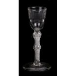 A late 18th / early 19th century wine glass with knopped air twist stem, 17cms (6.5ins) high.