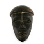 African / Tribal Art. An African wooden Dan mask from the Ivory coast, 24cms (9.5ins) high.