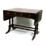 A mahogany sofa table on twin turned reeded supports and splayed legs, with two frieze drawers and