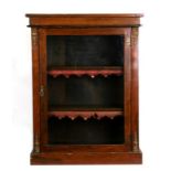 A 19th century pier cabinet of small proportions with a glazed door enclosing a shelved interior, on