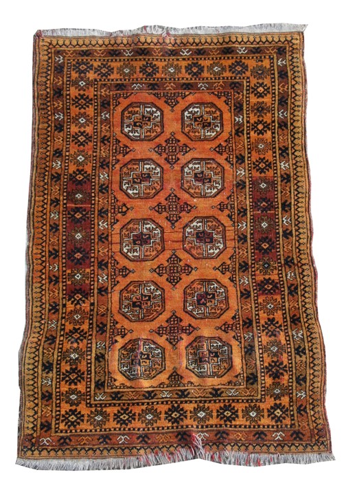 A Persian Bokhara rug with two rows of five central medallions on a burnt orange ground, 77 by