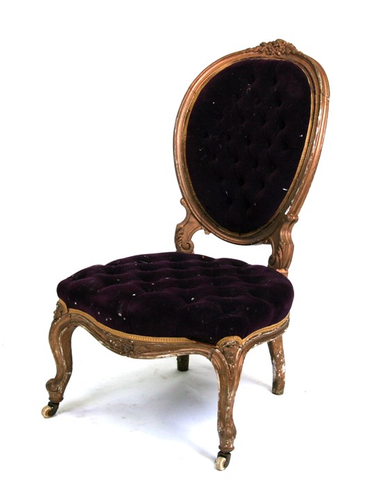 A gilded salon chair with button upholstered seat and back.