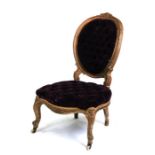 A gilded salon chair with button upholstered seat and back.