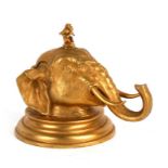 A gilt metal elephant head inkwell with seated monkey finial, 13cms (5ins) high.Condition Report
