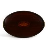 A 19th century mahogany oval two-handled tray with central central shell inlay, 57cms (22.5ins).