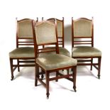 A set of four Edwardian dining chairs with upholstered seats and backs.