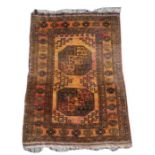 A Persian Bokhara rug with two central medallions on a burnt orange ground, 80 by 110cms (31.5 by