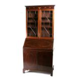 An Edwardian inlaid mahogany bureau bookcase, the astragal glazed doors enclosing a shelved interior
