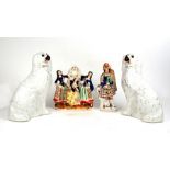 A pair of Staffordshire Pottery spaniels with glass eyes, 33cms (13ins) high; together with a