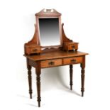 A late 19th century satin walnut dressing table with two small jewellery drawers above two frieze