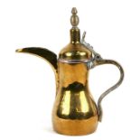 A Turkish / Islamic brass and copper dallah coffee pot, 27cms (10.5ins) high.