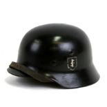 An M1940 Dutch SS combat helmet with liner and chin strap. Makers mark to inside ET 64 with a