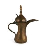 A Turkish / Islamic brass and copper dallah coffee pot with impressed mark to the body, 30cms (11.