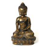 A gilt bronze figure of Buddha seated on a lotus base, 30cms (12ins) high.