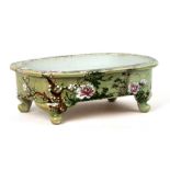 A Chinese celadon glaze shallow planter decorated with flowers, 36cms (14ins) wide.Condition