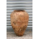 A large terracotta olive jar with banded decoration, 63cms (24.8ins) high.