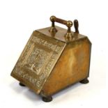 A brass coal scuttle.