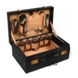 A gentleman's fitted vanity case with silver mounted bottles and brushes.