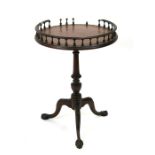 A Victorian mahogany occasional table, the circular galleried top on a turned column and tripod