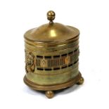 A brass oval log box with lion mask handles, 43cms (17ins) wide.