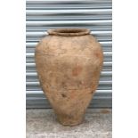 A large terracotta olive jar with banded decoration, 63cms (24.8ins) high.
