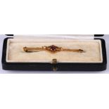 A 15ct gold garnet and pearl bar brooch, boxed.