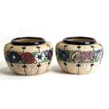 A pair of amphora vases decorated with flowers in enamel colours, 18cms (7ins) diameter.