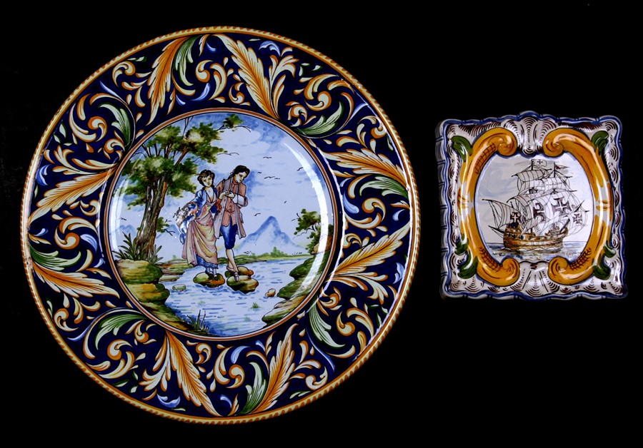 A continental maiolica style charger decorated with a young couple within a foliate border, 37cms (