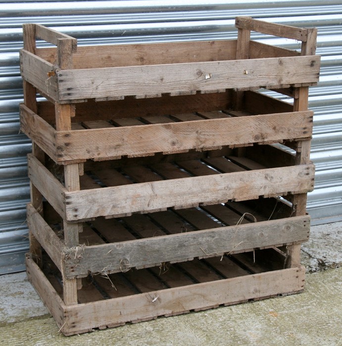 A group of five wooden apple crates.