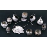 A quantity of Indian / Burmese white metal condiments to include salts, peppers and mustard pots (